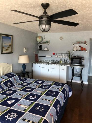 a bedroom with a bed and a ceiling fan at Capri Beach Hotel in Corpus Christi