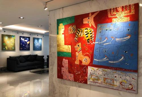 a large painting on a wall in a room at K.C Residence in Yangon