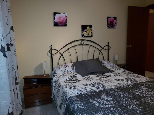 a bedroom with a bed with a black and white blanket at Can Josep in Aldover