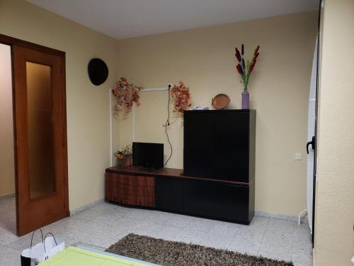 a living room with a television and a mirror at Can Josep in Aldover