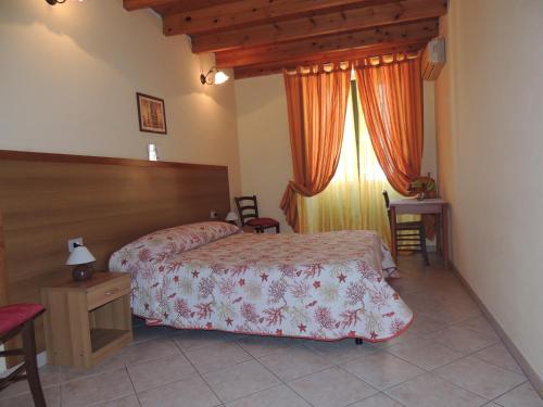 a hotel room with two beds and a window at La marina in Cagliari