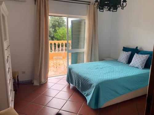 フェラグドにあるVilla Alcarrosaのベッドルーム1室(ベッド1台付)、バルコニーへのドアが備わります。