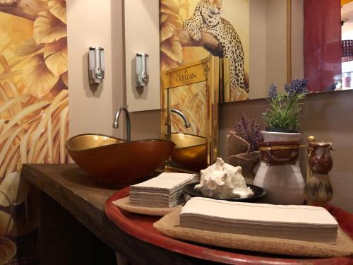 a bathroom with a bowl and a sink on a table at Hotel Villa Belvedere in Bonassola