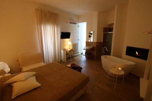 Televízia a/alebo spoločenská miestnosť v ubytovaní San Michele Luxury Rooms