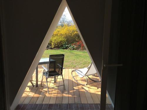 a view of a porch with a table and chairs at Triangel in Schmilau