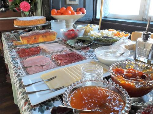 a table topped with lots of different types of food at Casa Das Obras in Manteigas