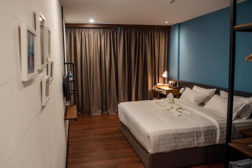Postel nebo postele na pokoji v ubytování O&G Hotel Parit Buntar