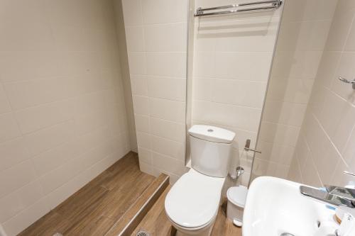 a bathroom with a toilet and a sink at Cloud 3 Apartment in Kalamata