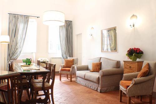 a living room with a table and a couch at BorgoDeGreci Apartments in Florence