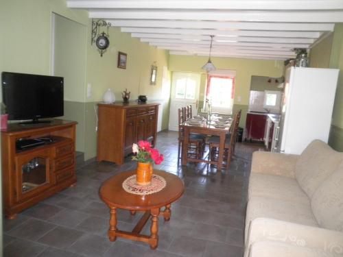 a living room with a couch and a table at GITE DES ROCHES in La Roche-Vanneau