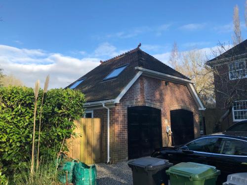 a brick house with a car parked in front of it at Idyllic Studio Flat in Winchester