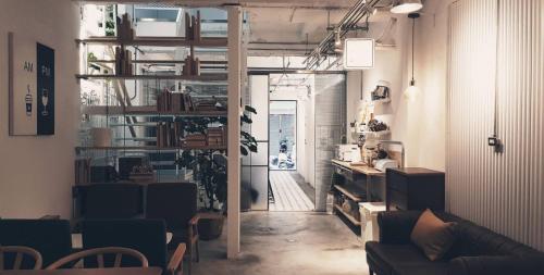 a living room with a couch and a book shelf at 188 Station in Tainan