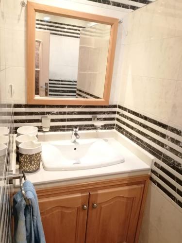 a bathroom with a sink and a mirror at la baie de Tanger in Tangier