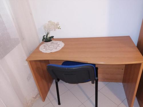 a wooden desk with a blue chair in a room at VILLA ELENA in Vico Equense