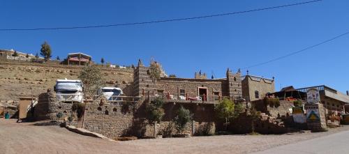 a truck parked on the side of a brick building at Auberge Amazigh in Tamtetoucht