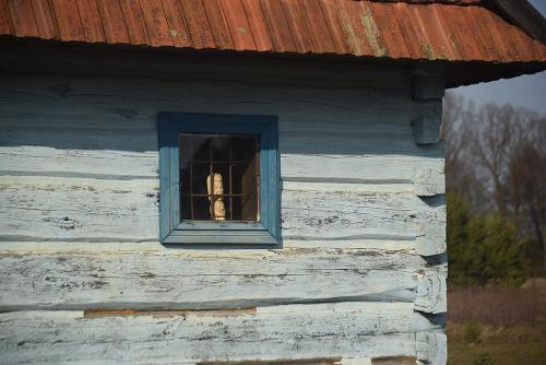 a window of a building with a statue in it at Grenlanda in Ulanów