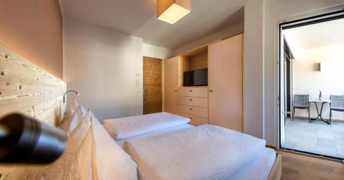 a bedroom with two beds and a large window at Apartment 39012 in Merano