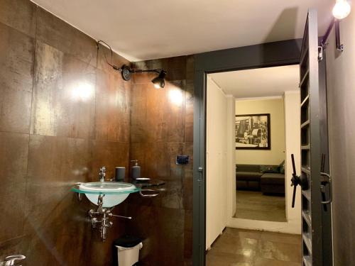 a bathroom with a sink and a room with a couch at Fra Storia e Modernità in Milan