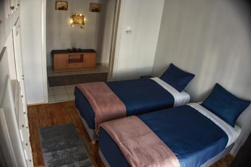 - une chambre avec 2 lits et une télévision dans l'établissement The Tranquility House Ioannina, à Ioannina