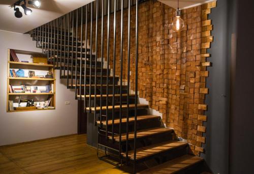 a staircase in a room with a brick wall at Chemodann Kazbegi in Stepantsminda