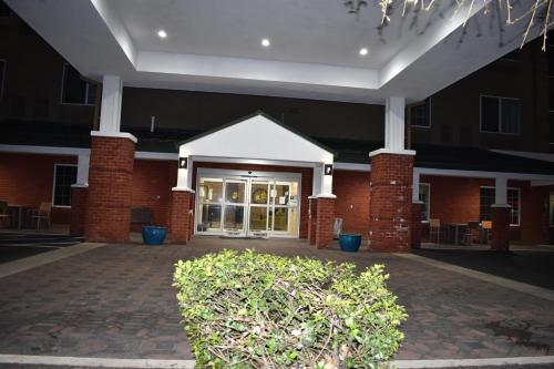 a large brick building with a large glass door at Country Inn & Suites by Radisson, Hagerstown, MD in Hagerstown