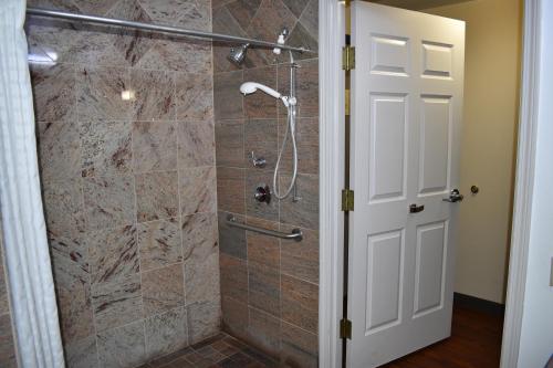a bathroom with a shower with a glass door at Country Inn & Suites by Radisson, Hagerstown, MD in Hagerstown