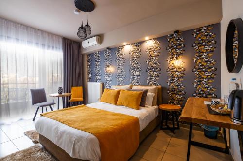 a hotel room with a bed and a table and chairs at Limani Comfort Rooms in Thessaloniki