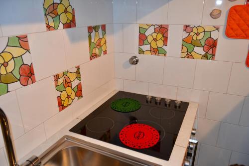 a kitchen with a stove top oven in a sink at Eden Apartment in Anacapri