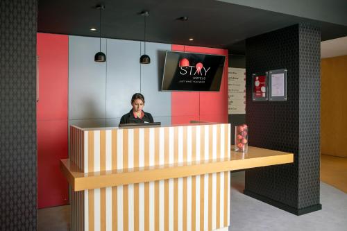 a man standing in front of a counter in a restaurant at Stay Hotel Faro Centro in Faro