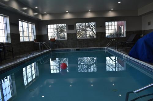 a swimming pool with a red ball in the water at Country Inn & Suites by Radisson, Hagerstown, MD in Hagerstown