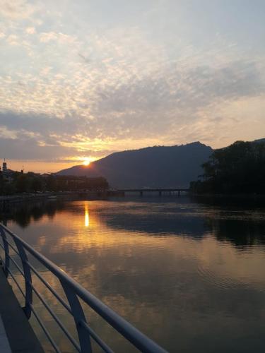 a sunset over a river with a bridge at Veneto Civico 17 in Sarnico