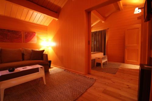 a living room with a couch and a table at Hotel Village in Aosta