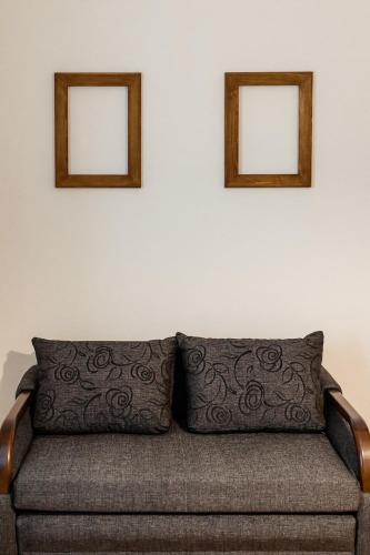 two pictures on the wall above a couch at Apartmány Hrady in Zuberec