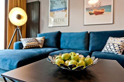 a bowl of fruit on a table in a living room at Villa Aqua BlueApart Jurata in Jurata