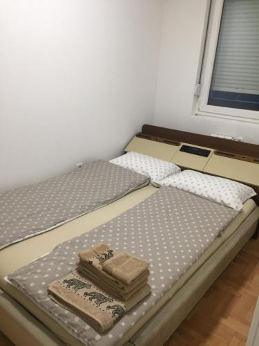 duas camas num quarto com toalhas em Stan na dan CENTAR em Šabac