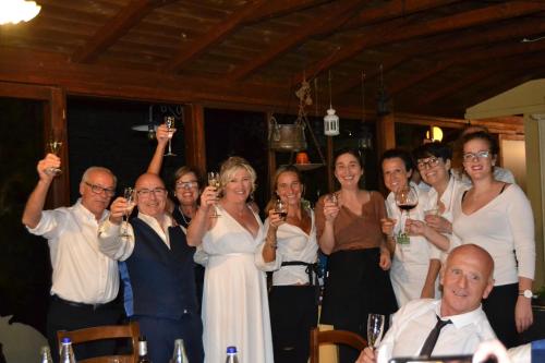 a group of people holding up glasses of wine at Agriturismo Santo Stefano in Polvano