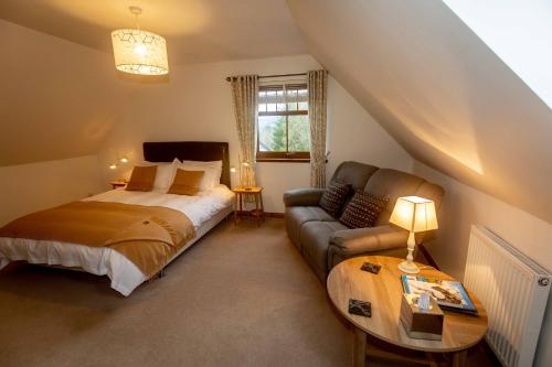 a bedroom with a bed and a couch at Uircheann Righ in Strontian
