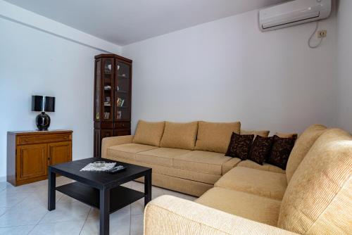 a living room with a couch and a coffee table at Guesthouse Drašković in Petrovac na Moru