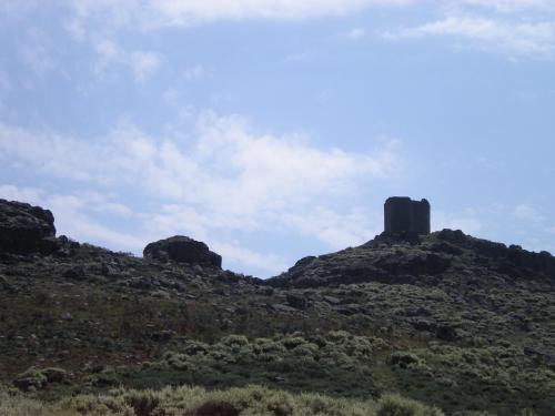 a rocky hill with two towers on top of it at Apartamento Zocailla Suite in Gata