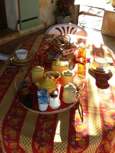 a table with food and other items on it at l'Oustaou B&B Piscine & Spa in Besse-sur-Issole