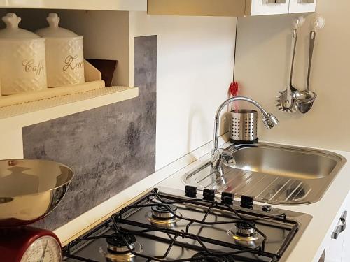 a kitchen with a sink and a stove at My Home in Bari