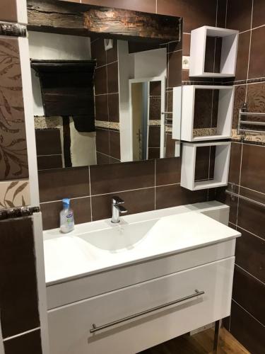 a bathroom with a white sink and a mirror at le zola in Figeac