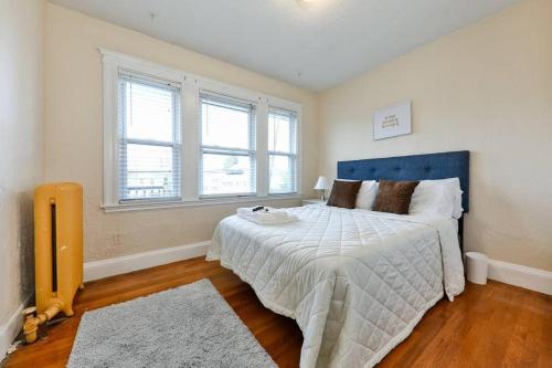 a bedroom with a large bed and a window at Medford Ellis in Medford