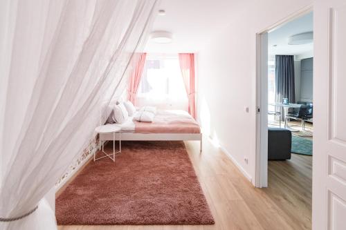 a small bedroom with a bed with a window at Spacious apartment close to the Old Town in Vilnius