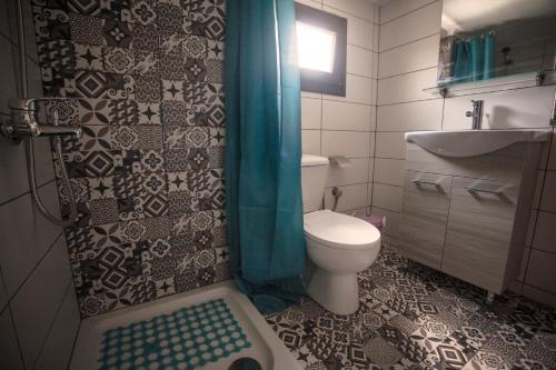 a bathroom with a toilet and a sink and a shower at Luminous Apartment in Agia Triada