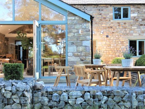 a patio with tables and chairs in front of a building at Lancaster Barn in Lancaster