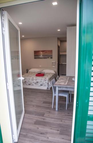 a room with a bed and a table with a tablektop at Casa delle Ginestre Bike in Sanremo