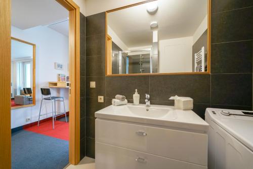 a bathroom with a sink and a mirror at Zora Exclusive Apartment in Bratislava