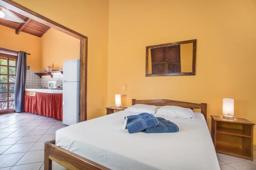 a bedroom with a bed and a white refrigerator at Hotel Bahia Esmeralda in Potrero
