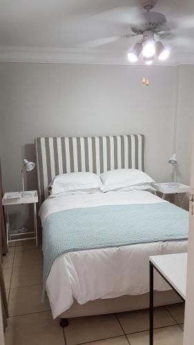 a bedroom with a large bed with two tables at Innes Road Durban Accommodation 2 bedroom private unit in Durban